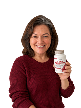 Woman holding a VITA1 Icelandic Astaxanthin 12mg bottle.